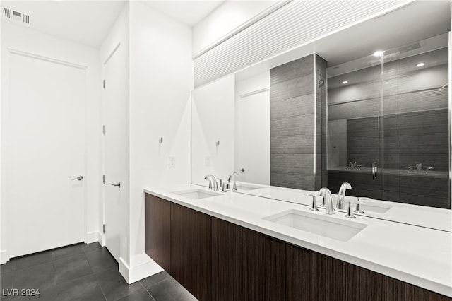 bathroom featuring vanity, a shower, and tile patterned flooring