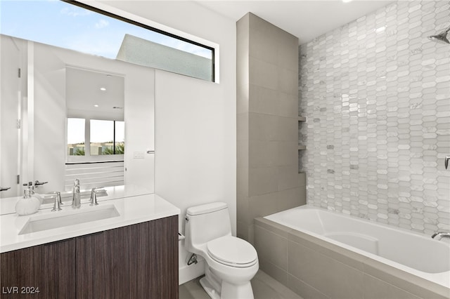 full bathroom with vanity, tiled shower / bath, toilet, and a skylight