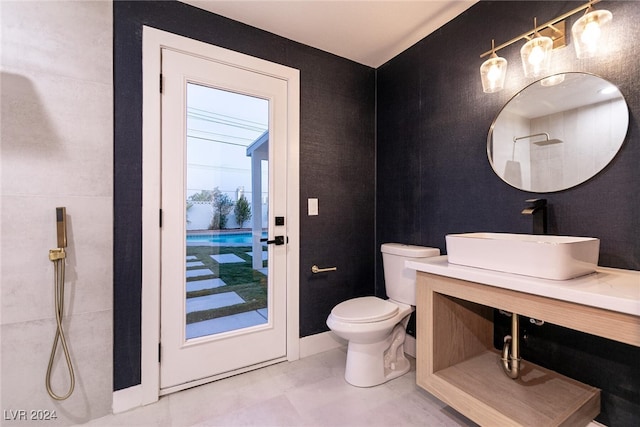 bathroom with vanity, toilet, and a shower