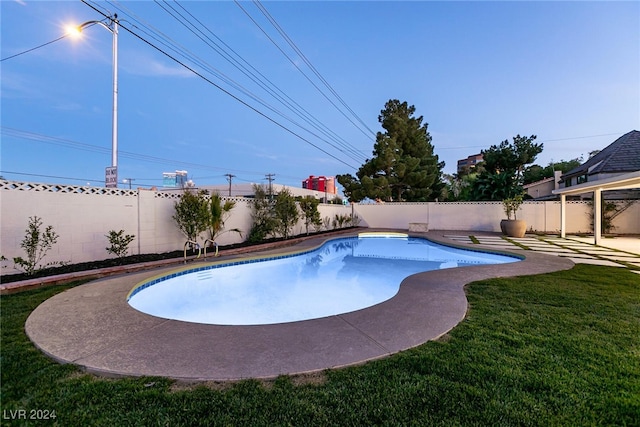 view of swimming pool featuring a lawn and a patio