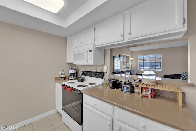 kitchen featuring white appliances, white cabinetry, and light tile patterned floors