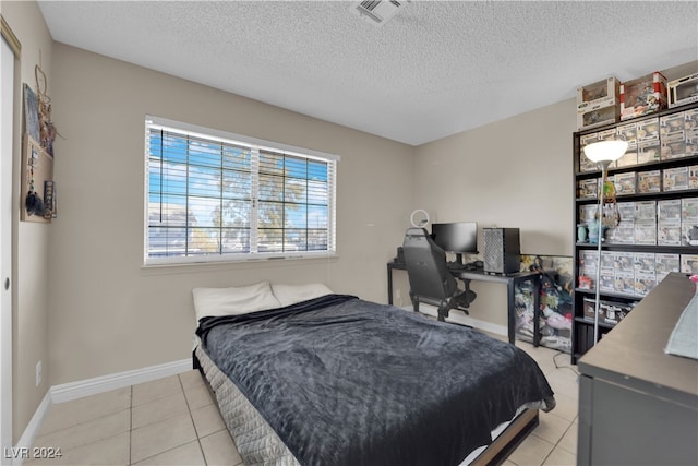 tiled bedroom with a textured ceiling