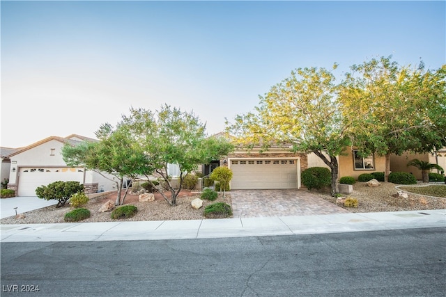 obstructed view of property with a garage