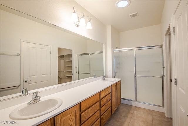 bathroom featuring vanity, an enclosed shower, and tile patterned floors