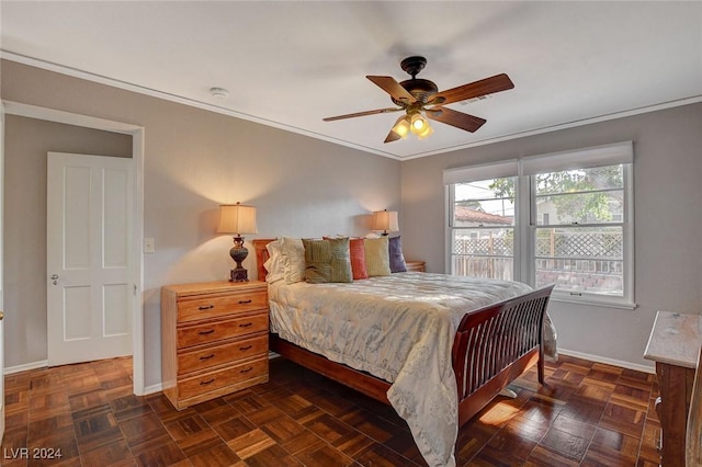 bedroom with ceiling fan, dark parquet floors, and crown molding