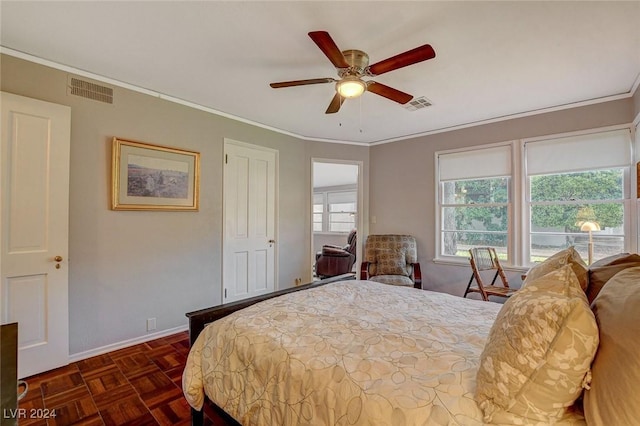 bedroom with ceiling fan, crown molding, and dark parquet floors