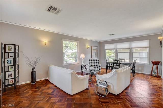 living room featuring dark parquet floors, plenty of natural light, and ornamental molding