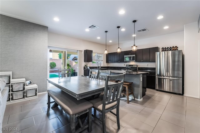 dining space with sink and light tile patterned floors