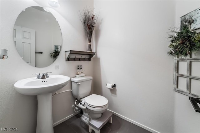 bathroom with toilet and tile patterned floors