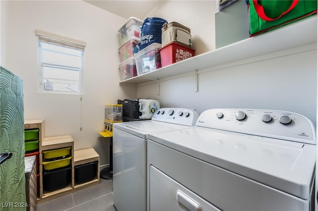 clothes washing area with independent washer and dryer and dark tile patterned flooring