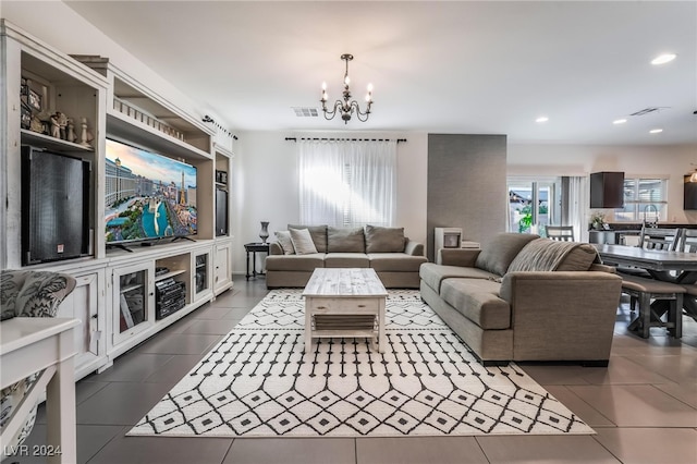 tiled living room featuring a notable chandelier