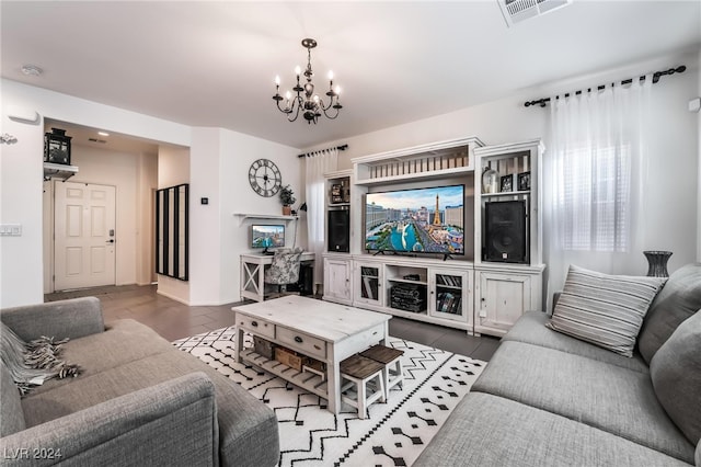 living room featuring a notable chandelier and dark wood-type flooring