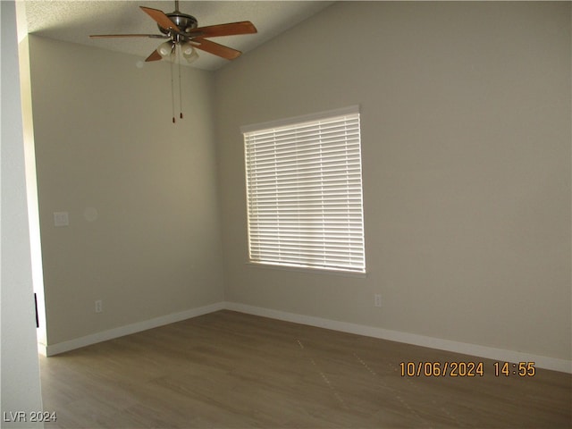 empty room with ceiling fan, wood-type flooring, and lofted ceiling