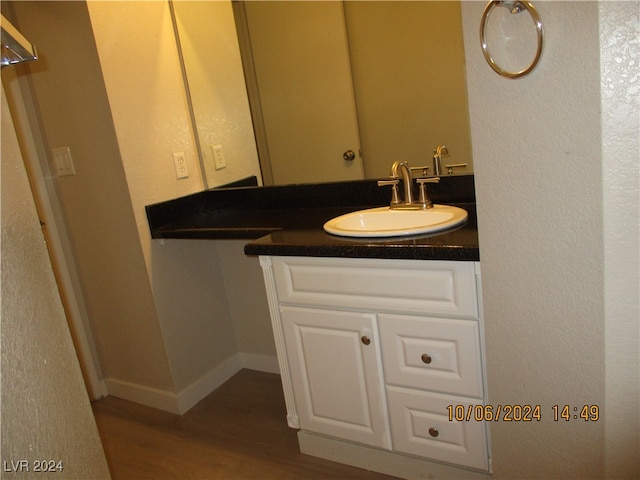 bathroom with vanity and wood-type flooring