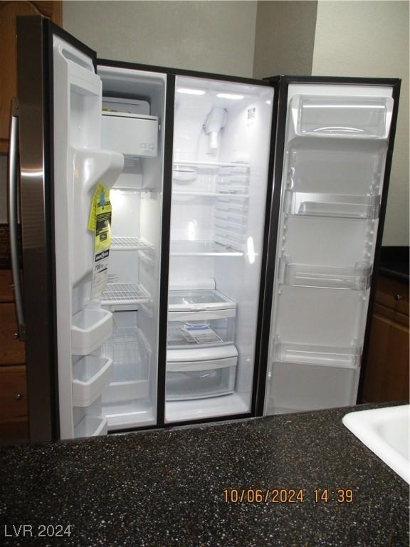 interior details featuring refrigerator with ice dispenser