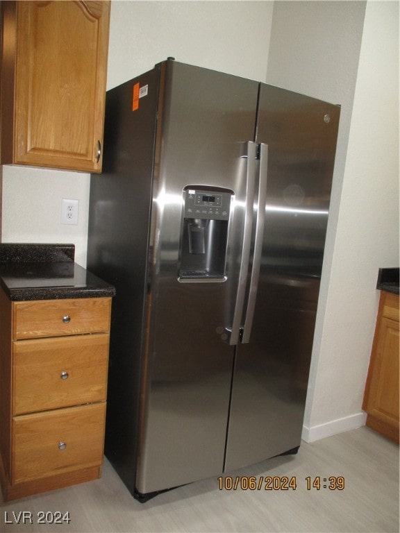 kitchen featuring stainless steel refrigerator with ice dispenser