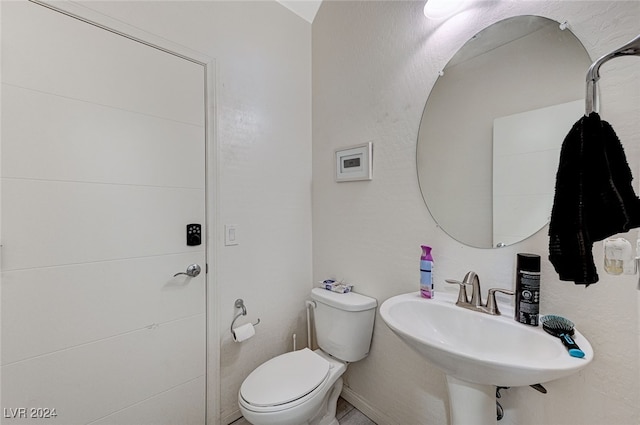 bathroom featuring sink and toilet