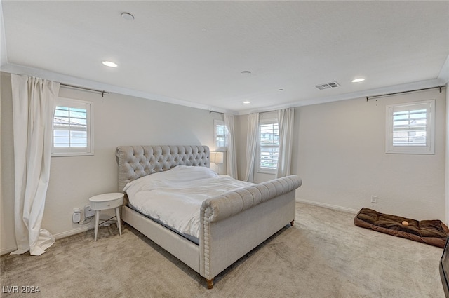 carpeted bedroom featuring multiple windows