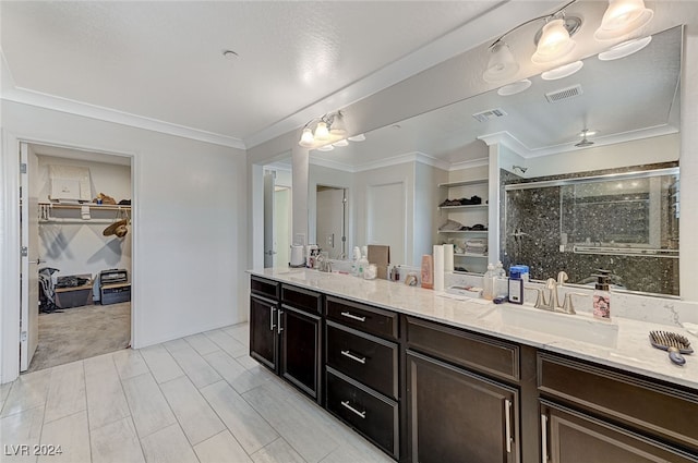 bathroom with crown molding, vanity, and an enclosed shower