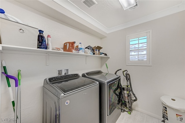 clothes washing area featuring separate washer and dryer