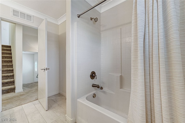 bathroom with shower / bath combination with curtain and ornamental molding