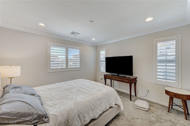 bedroom with carpet floors, crown molding, and multiple windows