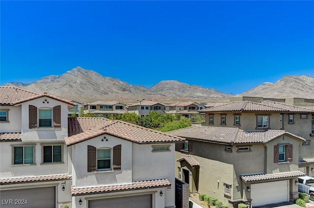 view of front of home featuring a mountain view and a garage