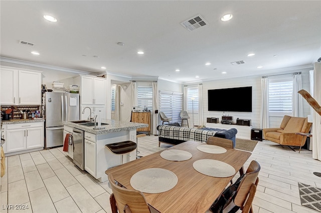 dining area featuring ornamental molding and sink