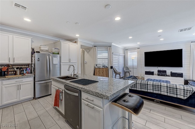 kitchen with white cabinets, appliances with stainless steel finishes, and sink