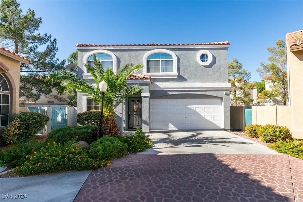 mediterranean / spanish home with a garage