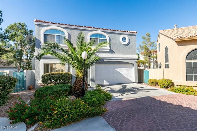 mediterranean / spanish-style house with a garage