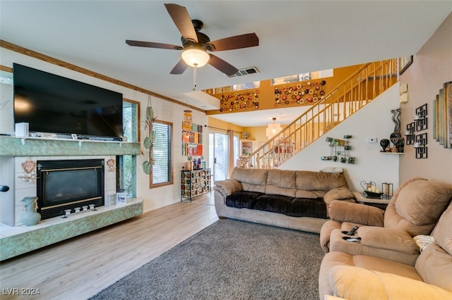 living room featuring ornamental molding, hardwood / wood-style floors, and ceiling fan