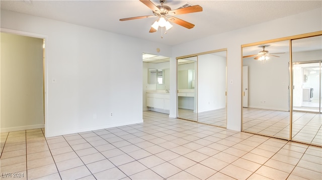 tiled empty room with ceiling fan