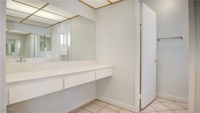 bathroom featuring vanity, tile patterned flooring, and a drop ceiling