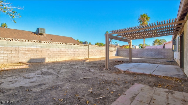 view of yard featuring central AC, a patio area, and a pergola