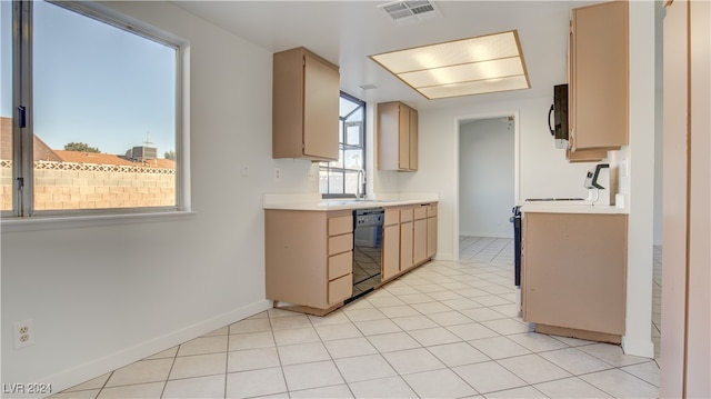 kitchen featuring light brown cabinetry, sink, black appliances, and light tile patterned flooring