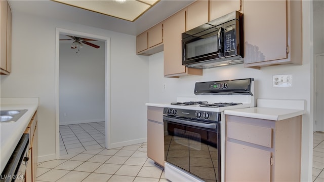 kitchen featuring sink, light tile patterned floors, range with gas stovetop, dishwasher, and ceiling fan