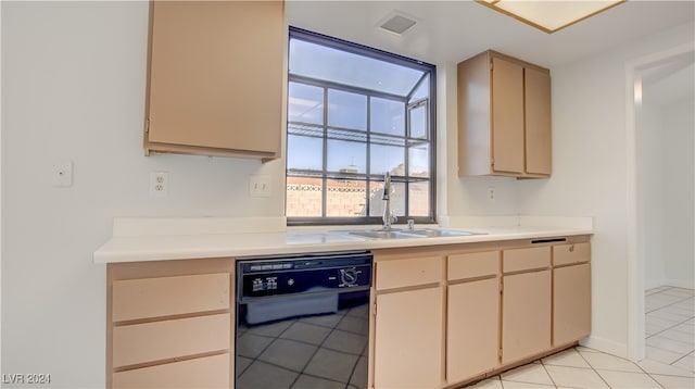 kitchen with black dishwasher, sink, light brown cabinetry, and light tile patterned floors