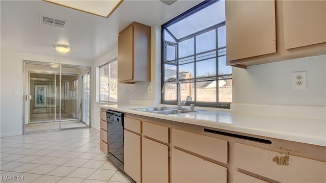 kitchen with sink, light tile patterned floors, and black dishwasher