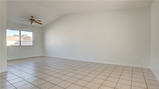 unfurnished room featuring ceiling fan, vaulted ceiling, and light tile patterned floors