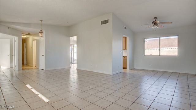 tiled empty room with lofted ceiling and ceiling fan