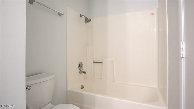 bathroom featuring shower / tub combination and toilet