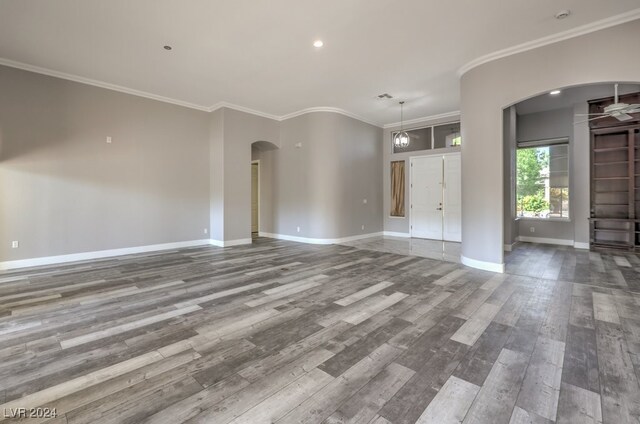 unfurnished living room featuring crown molding and hardwood / wood-style flooring