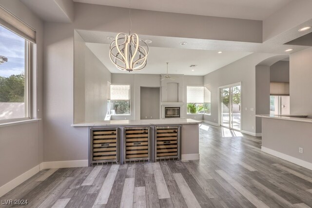 bar featuring beverage cooler and hardwood / wood-style floors