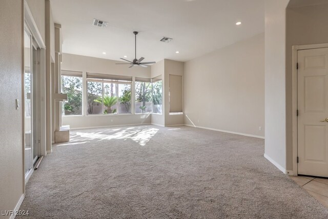 interior space featuring ceiling fan and light colored carpet