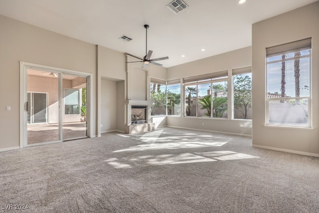 unfurnished living room with light carpet and ceiling fan