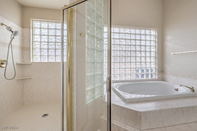 bathroom featuring tile patterned floors and plus walk in shower