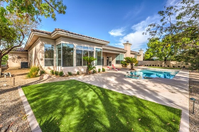 rear view of property with a yard, central AC, a fenced in pool, and a patio area