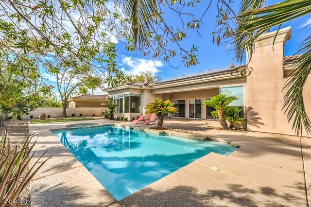 view of pool with french doors and a patio