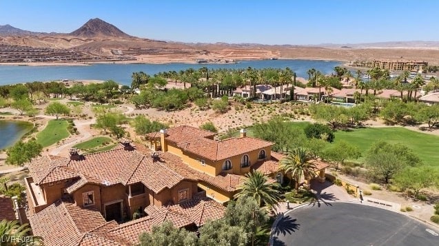 drone / aerial view featuring a water and mountain view